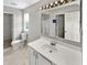 Bathroom featuring a toilet, large mirror, and vanity with a white countertop and cabinet at 11753 Pawleys Ct, Indianapolis, IN 46235