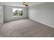 Bedroom features neutral carpet and a large window with natural light, creating a relaxing retreat at 11753 Pawleys Ct, Indianapolis, IN 46235