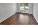 Neutral bedroom features hardwood floors, a large window, and plenty of natural light at 11753 Pawleys Ct, Indianapolis, IN 46235
