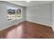 Neutral bedroom features hardwood floors, a large window, and neighborhood views at 11753 Pawleys Ct, Indianapolis, IN 46235