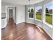 Sunny dining area with bay windows, hardwood floors, and backyard views at 11753 Pawleys Ct, Indianapolis, IN 46235
