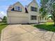 Two-story home features a two-car garage, dormer windows, and a well-maintained lawn at 11753 Pawleys Ct, Indianapolis, IN 46235