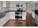 Clean kitchen features white cabinets, stainless steel appliances, and hardwood floors at 11753 Pawleys Ct, Indianapolis, IN 46235