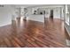 Open concept living room with kitchen in background featuring hardwood floors at 11753 Pawleys Ct, Indianapolis, IN 46235