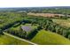 Breathtaking aerial view of a private home nestled amidst lush greenery with a serene pond at 11875 W 700 S, Columbus, IN 47201