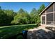 Expansive backyard featuring a lush lawn, mature trees, and the home's screened-in porch at 11875 W 700 S, Columbus, IN 47201
