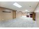 Spacious basement with carpet flooring, door leading outside and entertainment area with comfy chairs at 11875 W 700 S, Columbus, IN 47201
