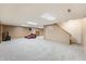 Large finished basement area with neutral walls, recessed lighting, and a staircase to upper level at 11875 W 700 S, Columbus, IN 47201