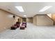 Spacious finished basement featuring neutral carpet, a storage cabinet, and cozy seating area at 11875 W 700 S, Columbus, IN 47201