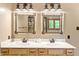 Stylish bathroom with double sinks, framed mirrors, and ample counter space on wood vanity at 11875 W 700 S, Columbus, IN 47201