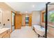Bright bathroom with tile floor, dual sinks, oak cabinets and a separate shower and tub at 11875 W 700 S, Columbus, IN 47201