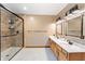This full bathroom offers a shower with glass door and double sink vanity with great lighting at 11875 W 700 S, Columbus, IN 47201