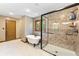 Spa-like bathroom featuring a standalone tub and a glass shower, with natural light from the window at 11875 W 700 S, Columbus, IN 47201