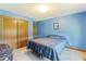 Cozy bedroom featuring blue walls, neutral carpeting, a full-sized bed and closet space at 11875 W 700 S, Columbus, IN 47201