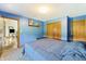 Comfortable bedroom featuring blue walls, plush carpeting, and a double-door closet, perfect for relaxation at 11875 W 700 S, Columbus, IN 47201