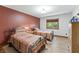 Cozy bedroom with two beds, a window allowing natural light into the space and nice decor at 11875 W 700 S, Columbus, IN 47201