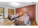 Comfortable bedroom featuring two beds, hardwood floors, closet and doorway to bathroom at 11875 W 700 S, Columbus, IN 47201