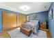 Inviting bedroom with wood floors, blue accent wall, and plenty of storage space in the double closets at 11875 W 700 S, Columbus, IN 47201