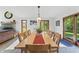 Formal dining room offers a long wooden table for ten and views of the fireplace and backyard at 11875 W 700 S, Columbus, IN 47201