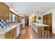 Bright, spacious kitchen with wood cabinetry, ample counter space, and charming blue-and-white tile accents at 11875 W 700 S, Columbus, IN 47201