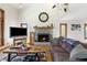 Open living room featuring a stone fireplace, large windows for natural light, and cozy furnishings for relaxation and comfort at 11875 W 700 S, Columbus, IN 47201