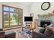 Cozy living room features a stone fireplace, large windows with scenic views, and comfortable seating for relaxing or entertaining at 11875 W 700 S, Columbus, IN 47201
