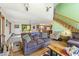 Sunlit living area flows into the kitchen and dining, enhanced by hardwood floors, a fireplace, and providing versatile living at 11875 W 700 S, Columbus, IN 47201