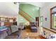 Bright and airy living room with hardwood floors, fireplace, and stairs, creating an inviting space for relaxation and entertaining at 11875 W 700 S, Columbus, IN 47201