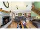 Spacious living room with a stone fireplace, hardwood floors, and a view into the kitchen and dining area for entertaining at 11875 W 700 S, Columbus, IN 47201