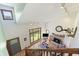 Bright living room featuring a stone fireplace, large windows, and open access to other living spaces at 11875 W 700 S, Columbus, IN 47201