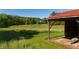 Scenic view of lush greenery and a charming outbuilding, with the home visible in the background offering a tranquil setting at 11875 W 700 S, Columbus, IN 47201