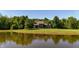 Still pond reflecting the beautiful home and surrounding mature trees on a sunny day at 11875 W 700 S, Columbus, IN 47201