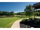 Scenic view of the pond and landscaping, with a charming home in the background offering a peaceful retreat at 11875 W 700 S, Columbus, IN 47201