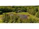 Aerial shot of a house overlooking a big pond with a large grassy field at 11875 W 700 S, Columbus, IN 47201