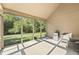 Bright screened-in porch with vaulted ceiling, views of the backyard, and a mini fridge at 11875 W 700 S, Columbus, IN 47201