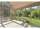 Enclosed sunroom with views of the lush backyard surrounded by mature trees at 11875 W 700 S, Columbus, IN 47201