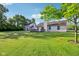 Lush green backyard with a well-manicured lawn and mature trees, perfect for outdoor activities and relaxation at 12250 Longstraw Dr, Indianapolis, IN 46236