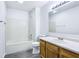Bathroom featuring a tub and shower combo and single sink vanity with wood cabinets at 12250 Longstraw Dr, Indianapolis, IN 46236