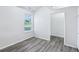 This bedroom has new luxury vinyl plank flooring and a large window to let in lots of light at 12250 Longstraw Dr, Indianapolis, IN 46236