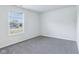 Bedroom featuring neutral walls, plush grey carpet, and large window for natural light at 12250 Longstraw Dr, Indianapolis, IN 46236