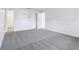 A bedroom featuring plush grey carpeting and neutral walls, with a hallway in view at 12250 Longstraw Dr, Indianapolis, IN 46236