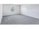A bedroom featuring plush grey carpeting and a large window to let in light at 12250 Longstraw Dr, Indianapolis, IN 46236