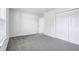 Bedroom featuring a double closet with plush grey carpet and neutral walls at 12250 Longstraw Dr, Indianapolis, IN 46236