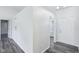 Hallway featuring modern flooring, neutral walls, and leading to other rooms at 12250 Longstraw Dr, Indianapolis, IN 46236