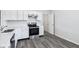 Modern kitchen featuring stainless steel appliances, white cabinets, and modern flooring at 12250 Longstraw Dr, Indianapolis, IN 46236