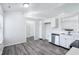 Bright kitchen features white cabinets, stainless steel dishwasher, and luxury vinyl plank flooring at 12250 Longstraw Dr, Indianapolis, IN 46236
