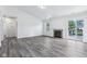 Inviting living room featuring neutral paint, a fireplace, and sliding doors at 12250 Longstraw Dr, Indianapolis, IN 46236