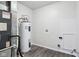Water heater in the utility room which has new luxury vinyl plank flooring at 12250 Longstraw Dr, Indianapolis, IN 46236