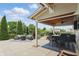 Spacious covered patio with outdoor seating and a view of the serene backyard pond at 1281 Jesse Ct, Greenwood, IN 46143