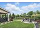 Scenic backyard featuring a cozy fire pit, lush greenery, and picturesque water views at 1281 Jesse Ct, Greenwood, IN 46143
